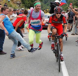 Illustration for article titled Spectator Picks Wrong Day To Run Alongside Tour de France Cyclist